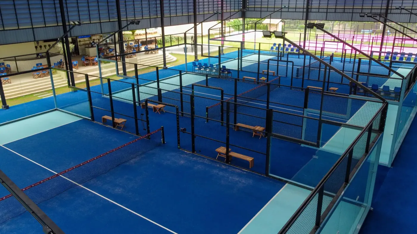 Indoor padel courts with blue turf at Padel Tropical Koh Samui