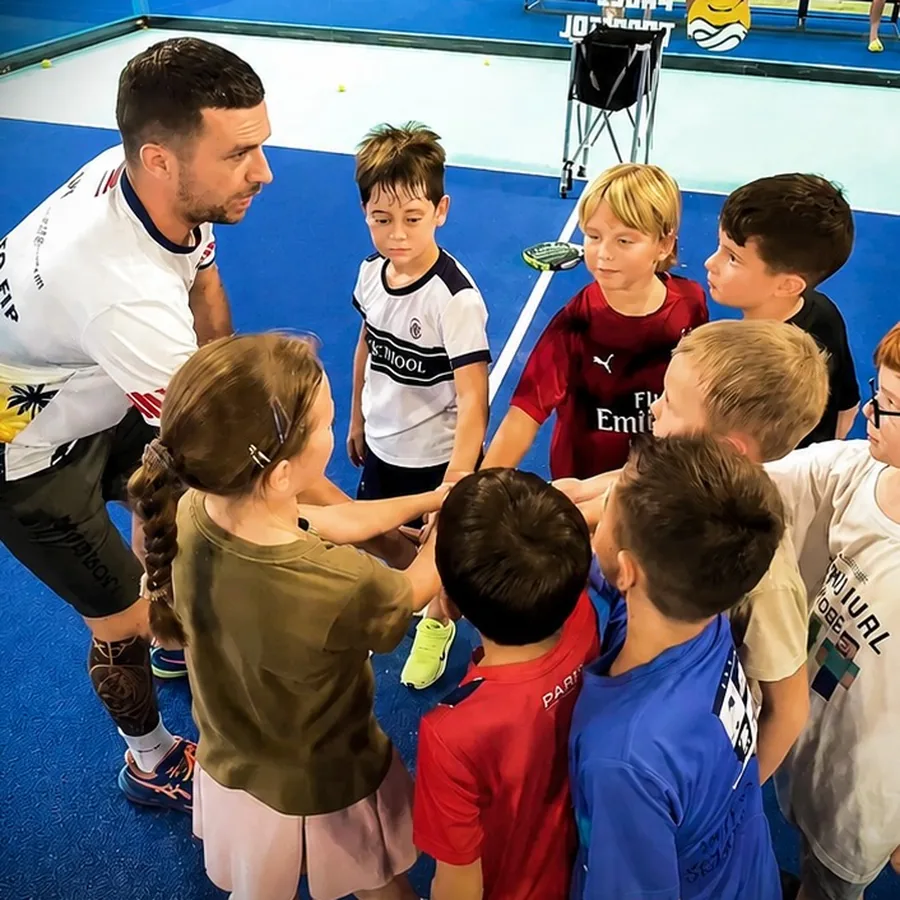 Coach teaching a group of children padel at Padel Tropical Koh Samui