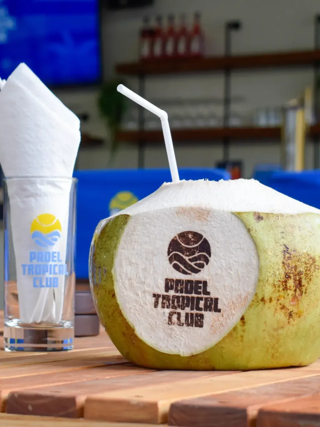 Fresh young coconut drink branded Padel Tropical at the courtside bar Koh Samui